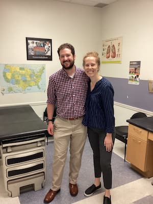 Grace and John standing in an examination room at Crossroads